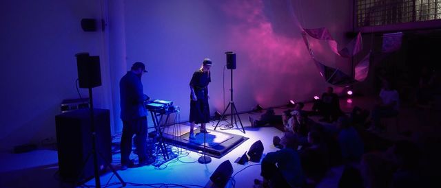 Man and woman in front of grey background